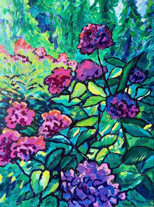 flowering bush in foreground, with evergreen trees in the background