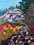 A rockface and talus slope in the mountains, surrounded by fall foliage