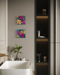 two small paintings of flowers on a bathroom wall