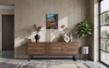 a colorful painting hung on a gray wall in a room with modern decor.