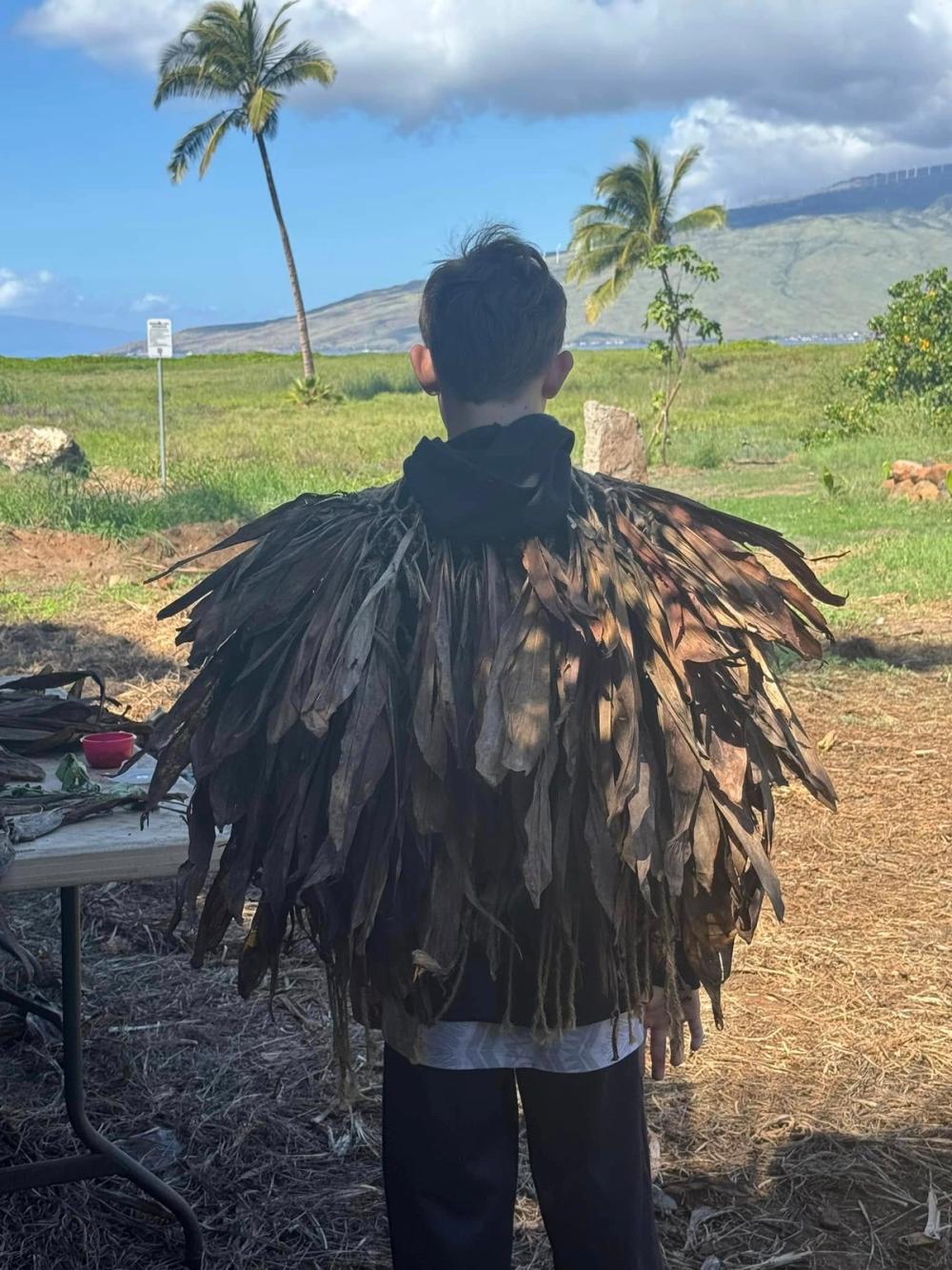 Person wearing leaf cape