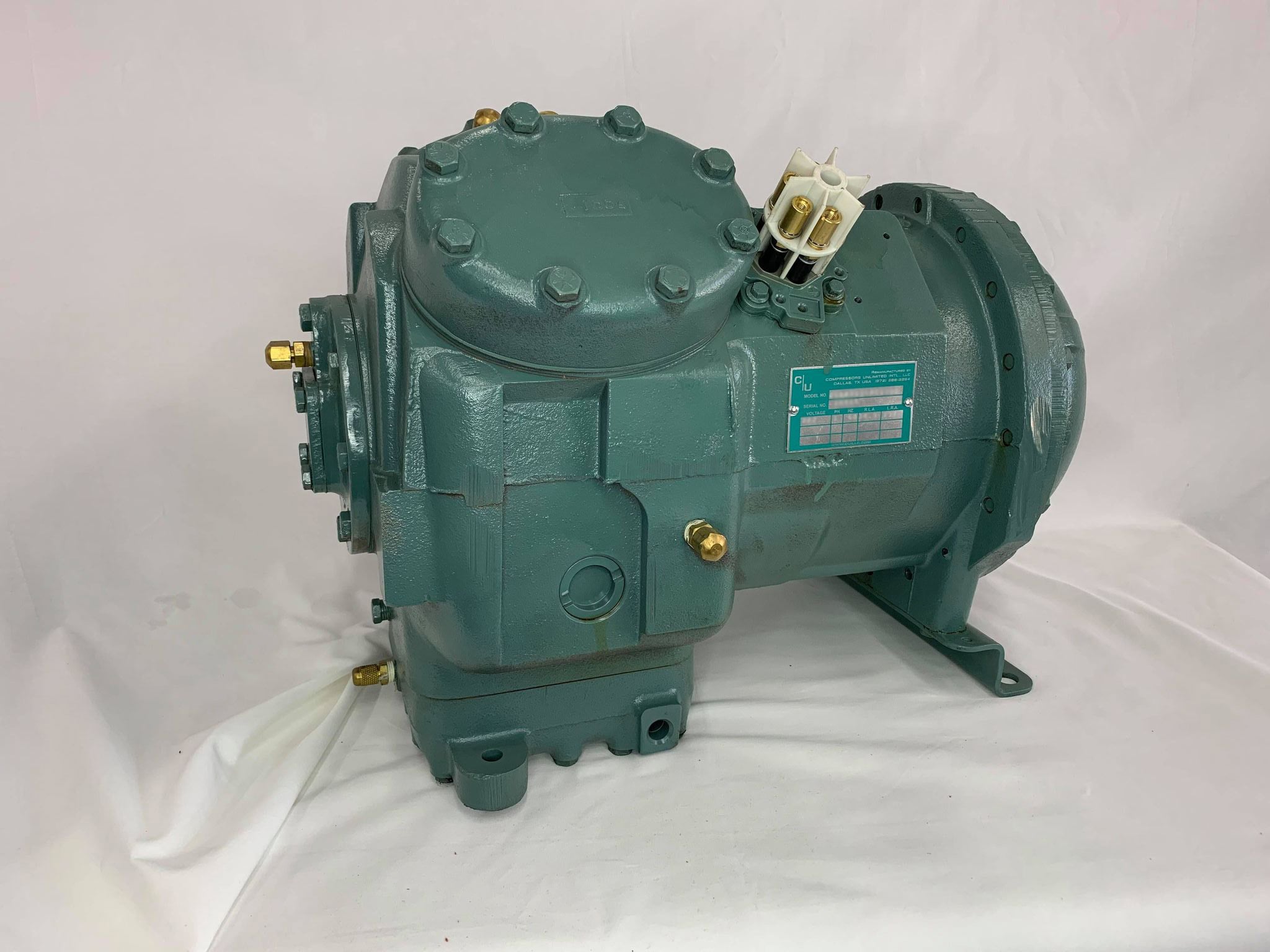 Remanufactured Carrier 06D718 semi-hermetic reciprocating compressor with visible nameplate and connections.
