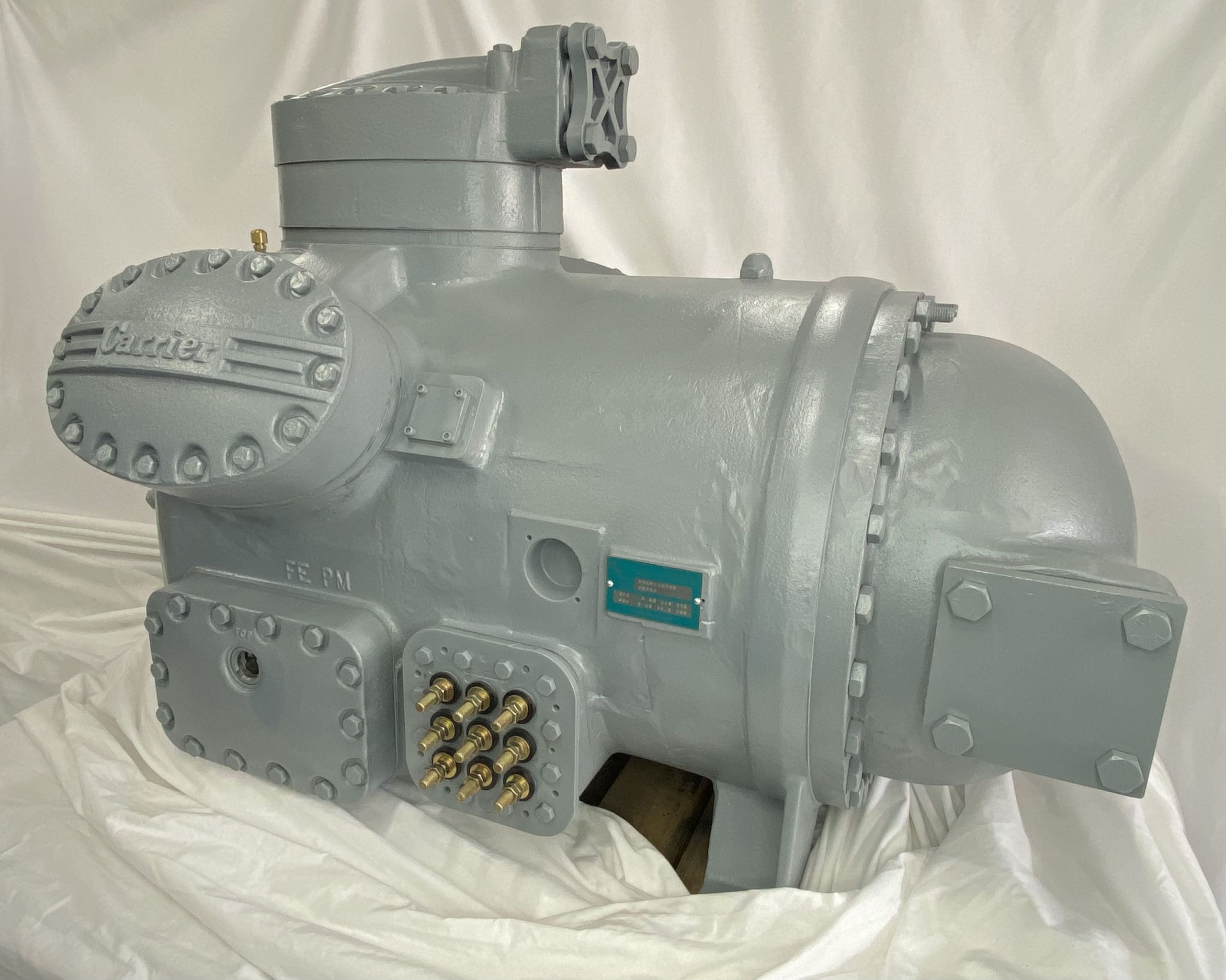 Remanufactured Carrier 06L semi-hermetic reciprocating compressor with visible branding and specifications plate.