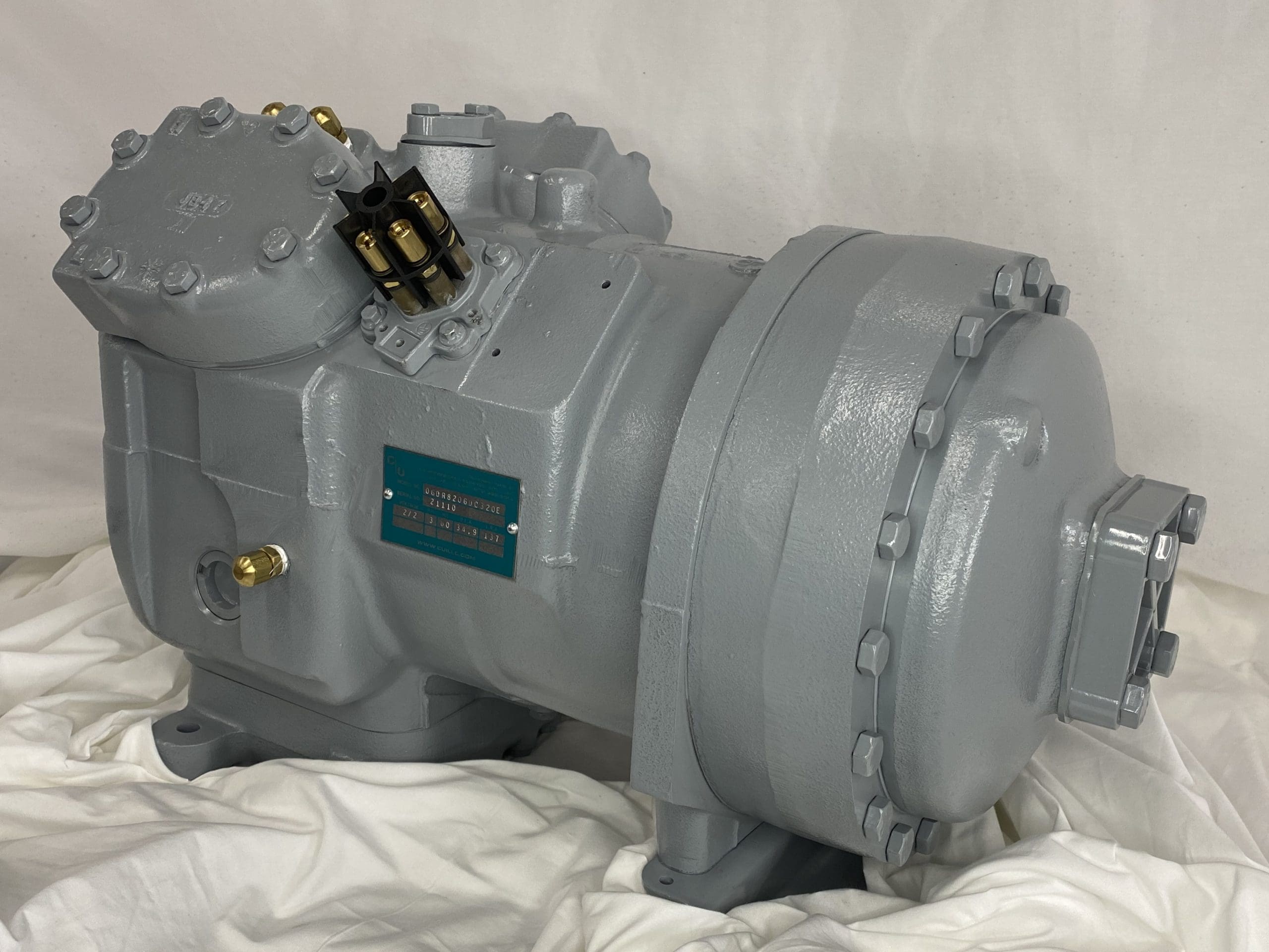 Remanufactured Carrier 06D semi-hermetic reciprocating compressor with data plate and piping.