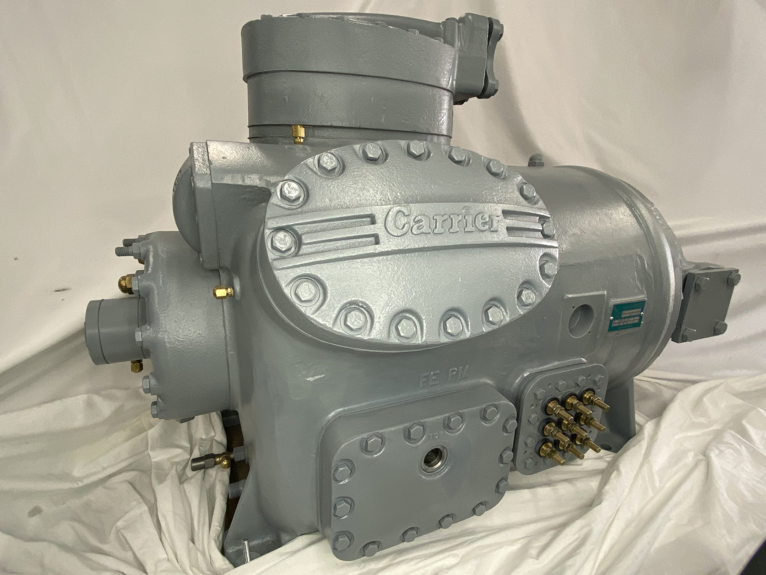 Remanufactured Carrier 06L semi-hermetic reciprocating compressor with visible Carrier branding and fittings.