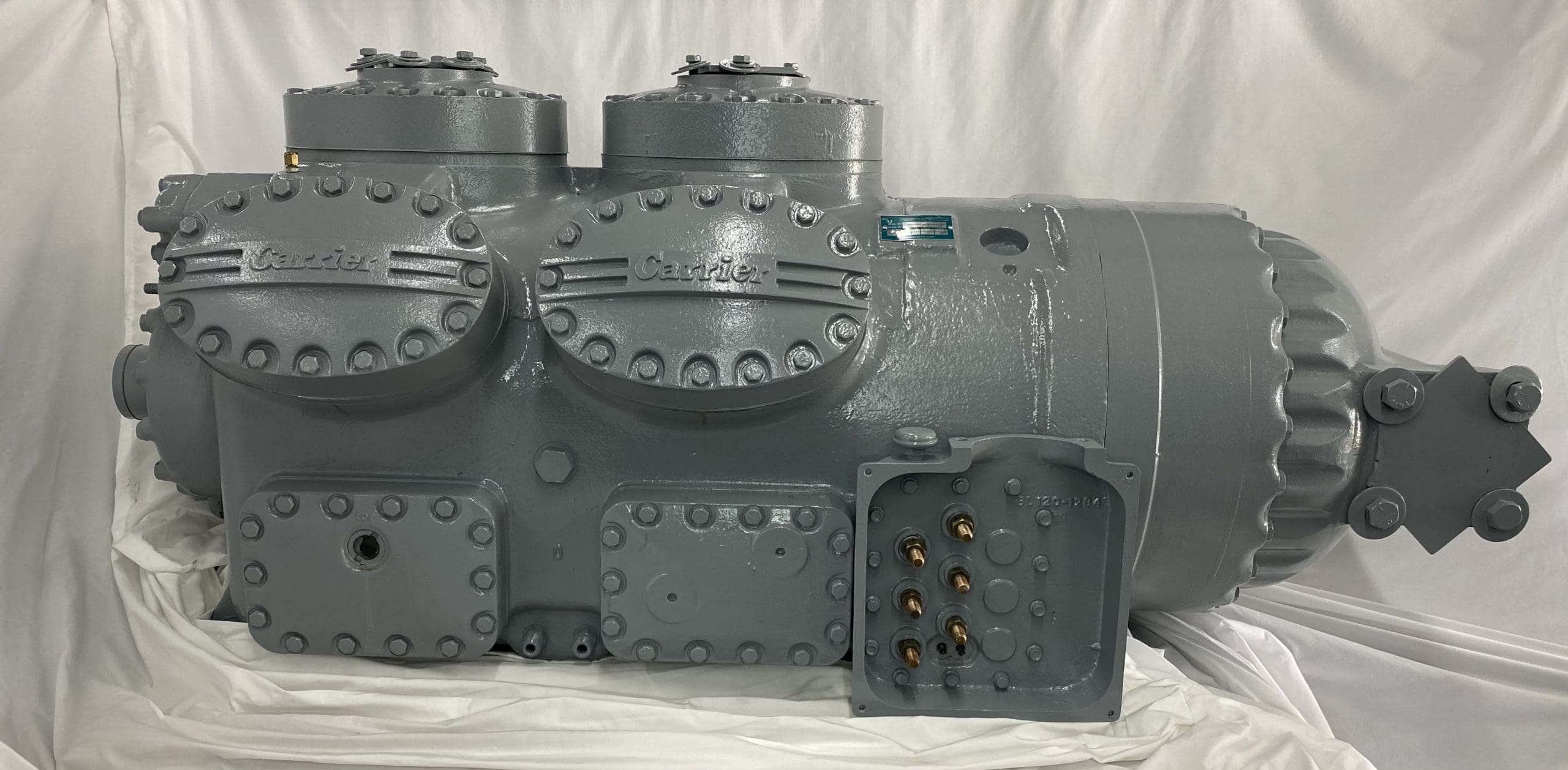 Remanufactured Carrier 06L Semi-Hermetic Reciprocating compressor with visible Carrier branding and components.