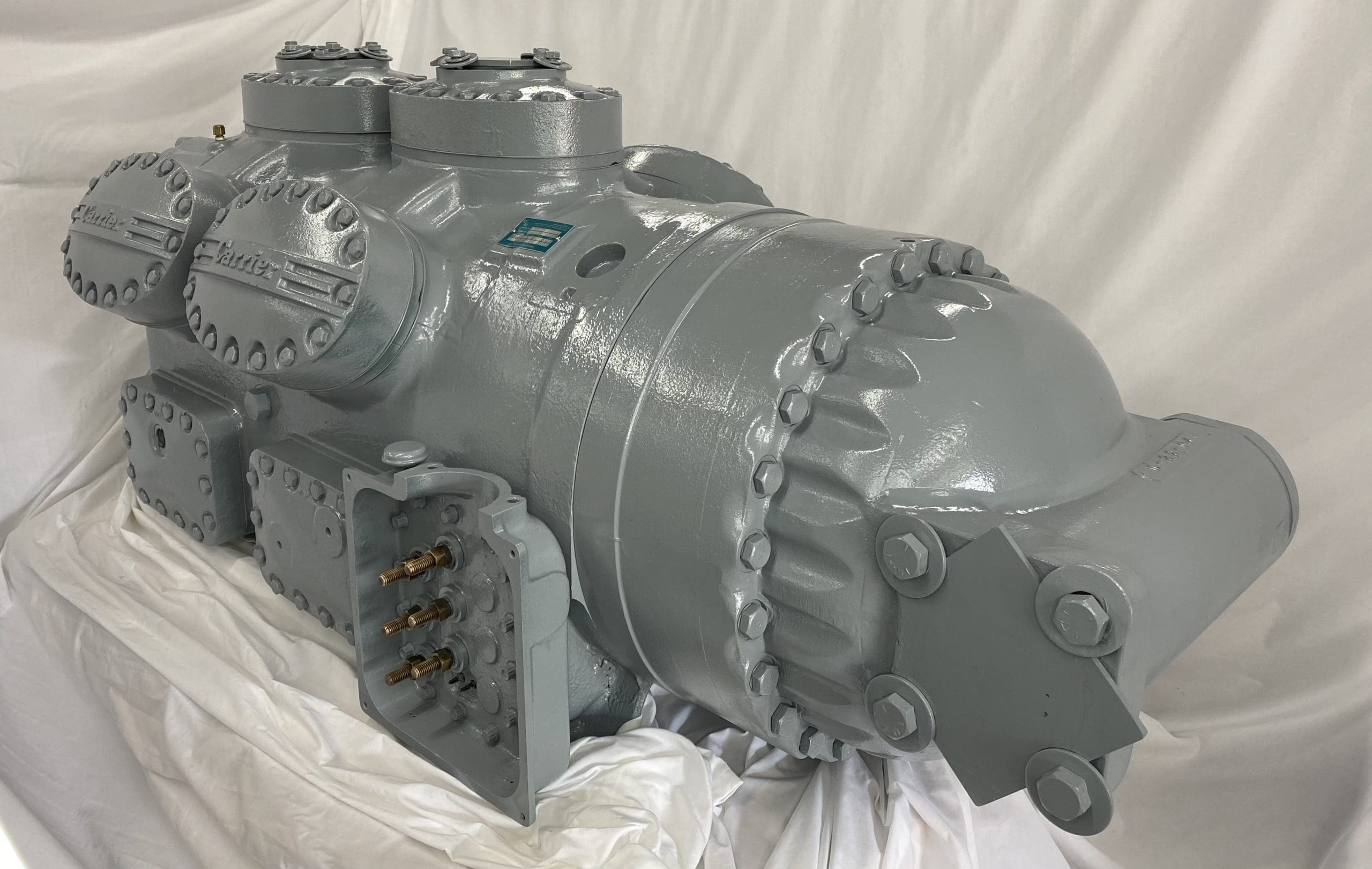 Remanufactured Carrier 06L reciprocating compressor with visible components and serial number plate.