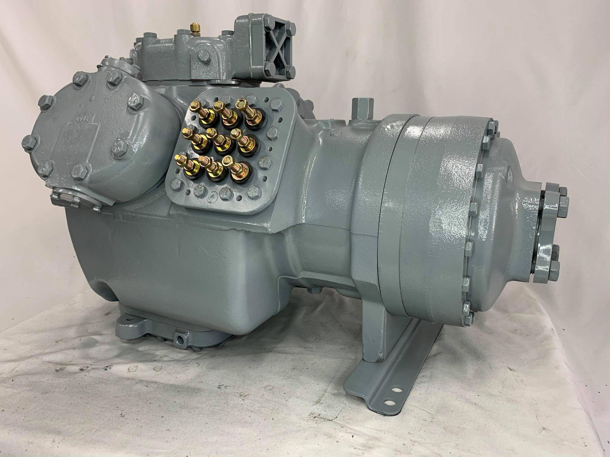 Remanufactured Carrier 06E semi-hermetic reciprocating compressor with R-22 refrigerant and multiple fittings.