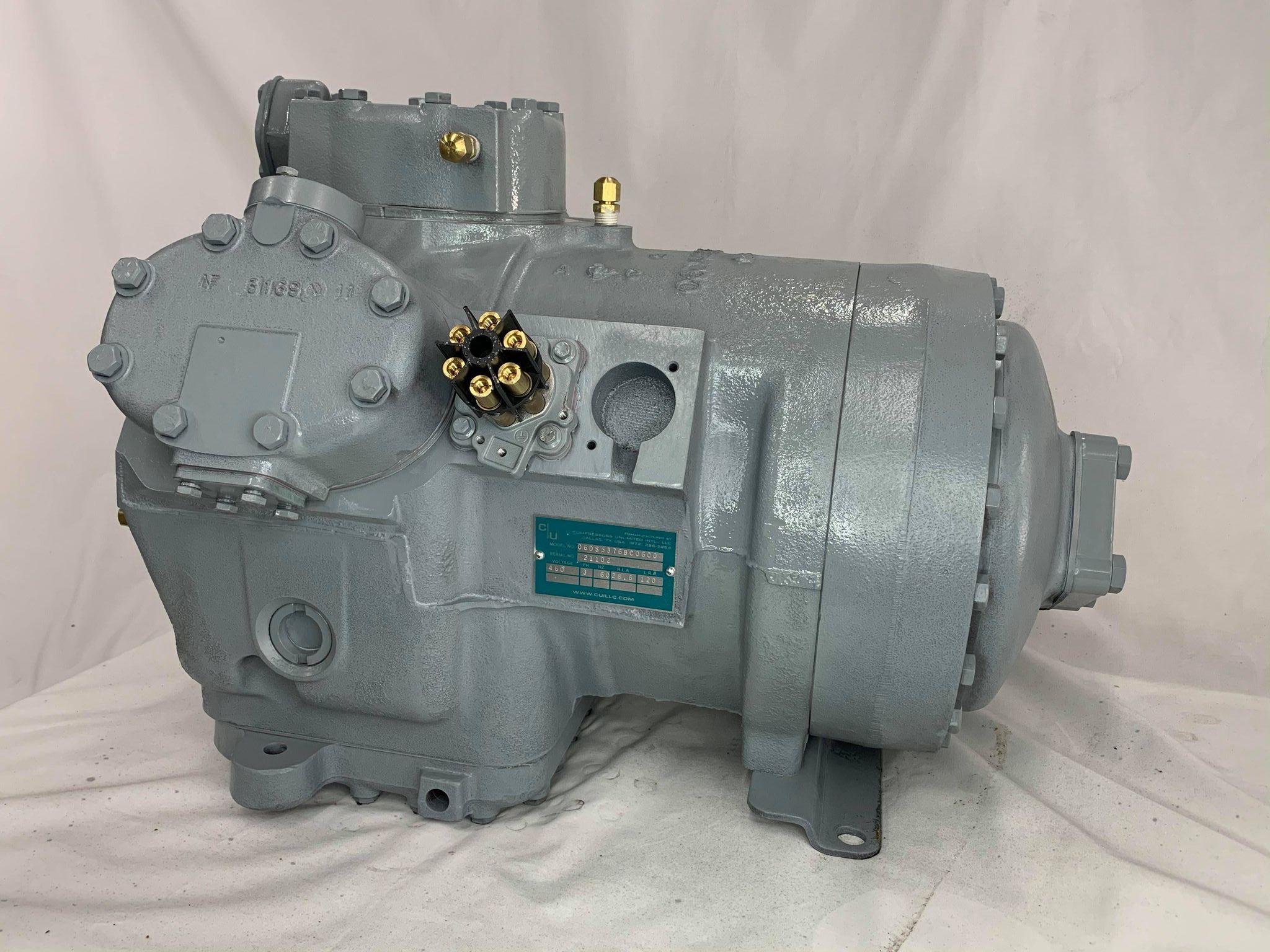 Remanufactured Carrier 06D semi-hermetic reciprocating compressor with data plate and inspection label.