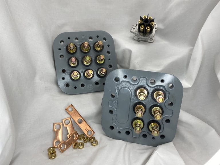 Carrier terminal assemblies, electrical bridge kits, and jumper bars for compressor connections.
