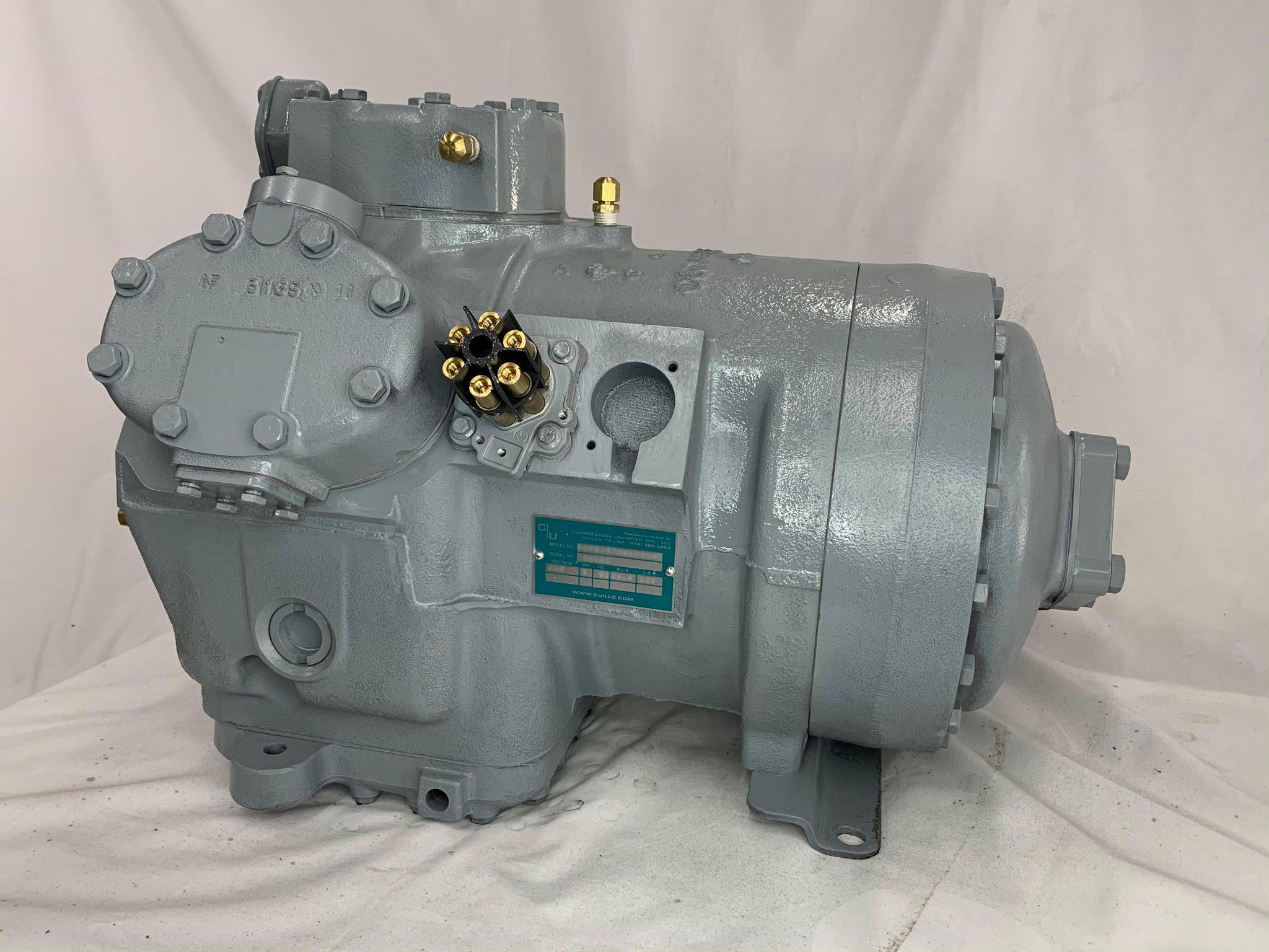 Remanufactured Carrier 06D reciprocating compressor with data plate and electrical connections.