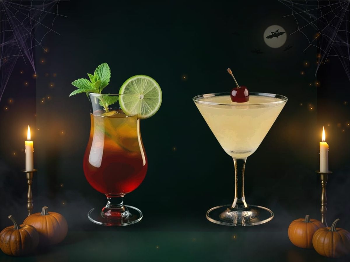 A Zombie in a hurricane glass with mint and lime beside a pale yellow Corpse Reviver in a stemmed glass, in a dark, foggy setting.