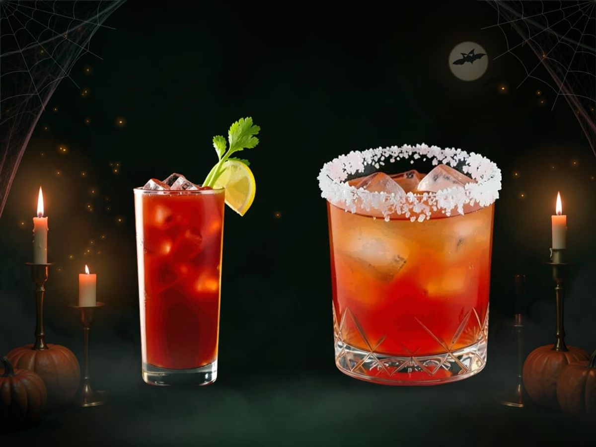 A tall red Bloody Mary beside a Vampiro in a rocks glass with a salted rim, on a dark background with candles and cobwebs.
