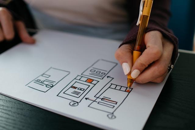 Person drawing a diagram for a mockup design