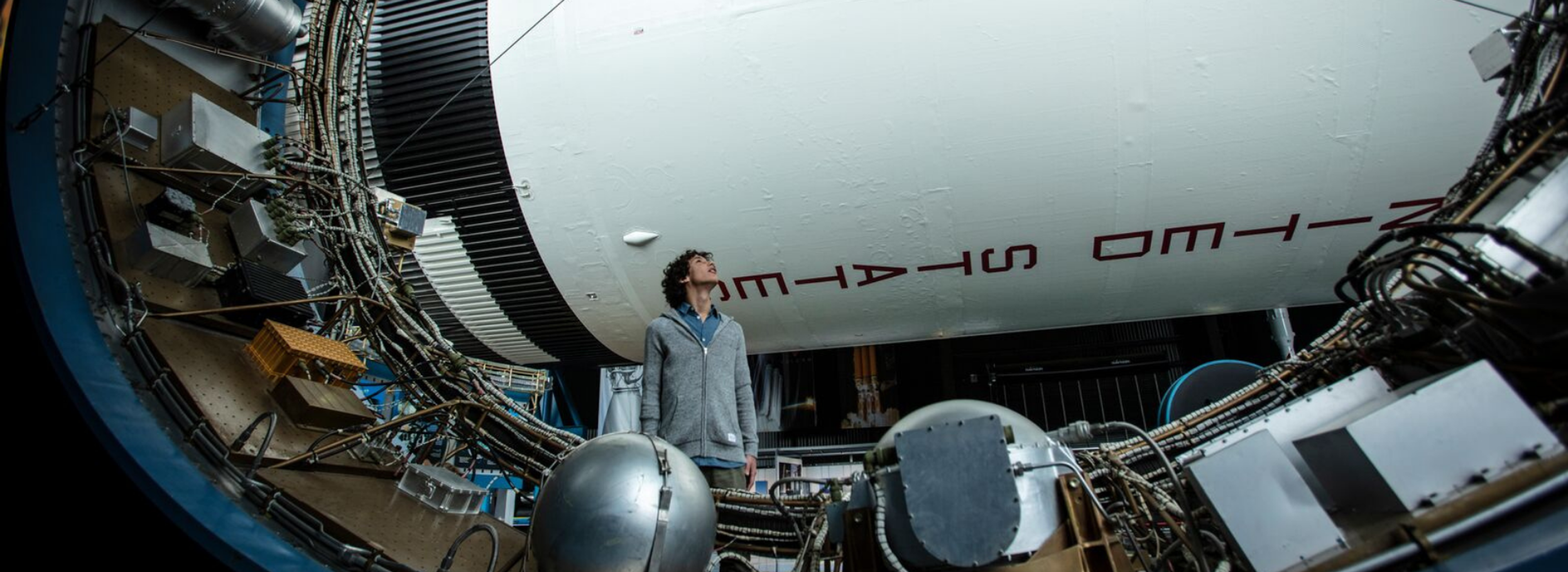 Person observing large space telescope equipment