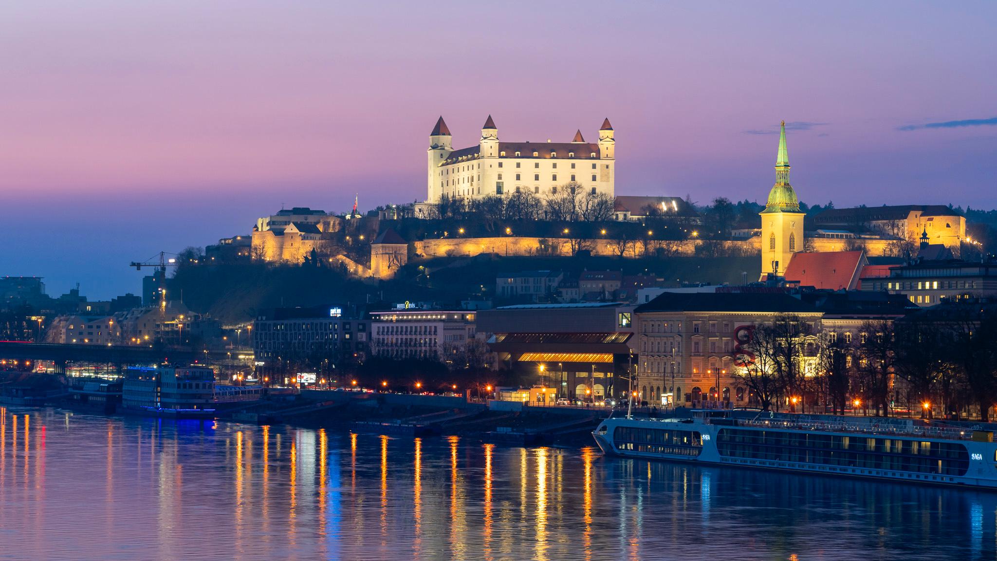 Bratislava Old Town medieval architecture reflected in Danube River at blue hour