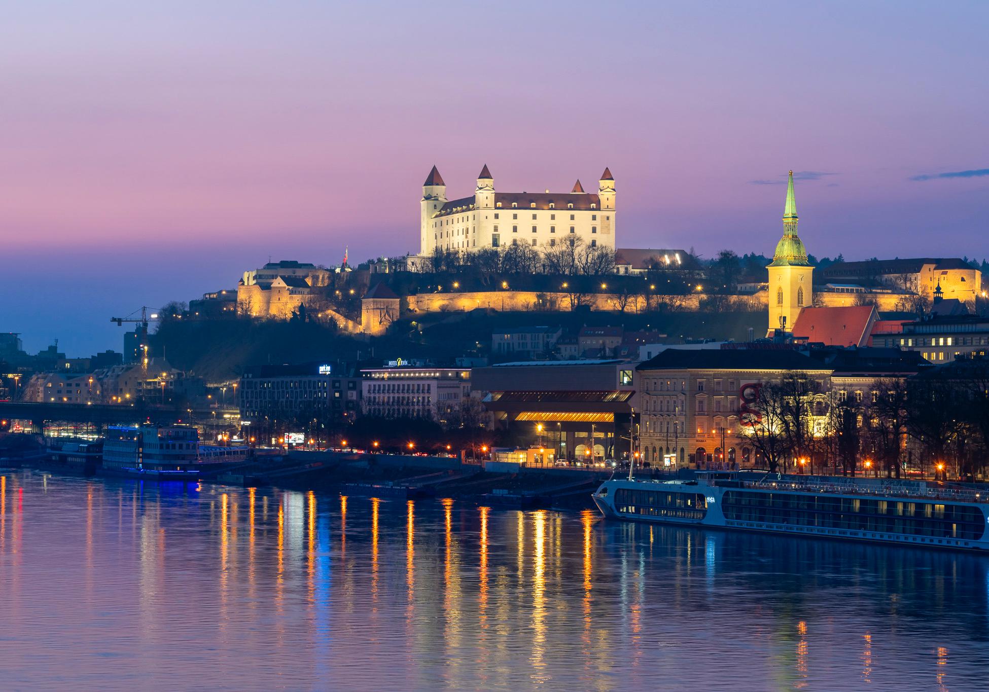 Bratislava Old Town medieval architecture reflected in Danube River at blue hour