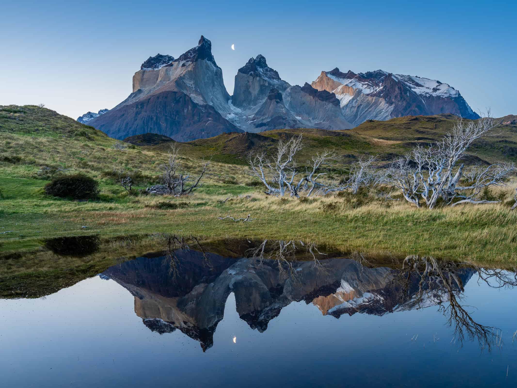 Mountain peaks reflected in still water at Torres del Paine, Chile