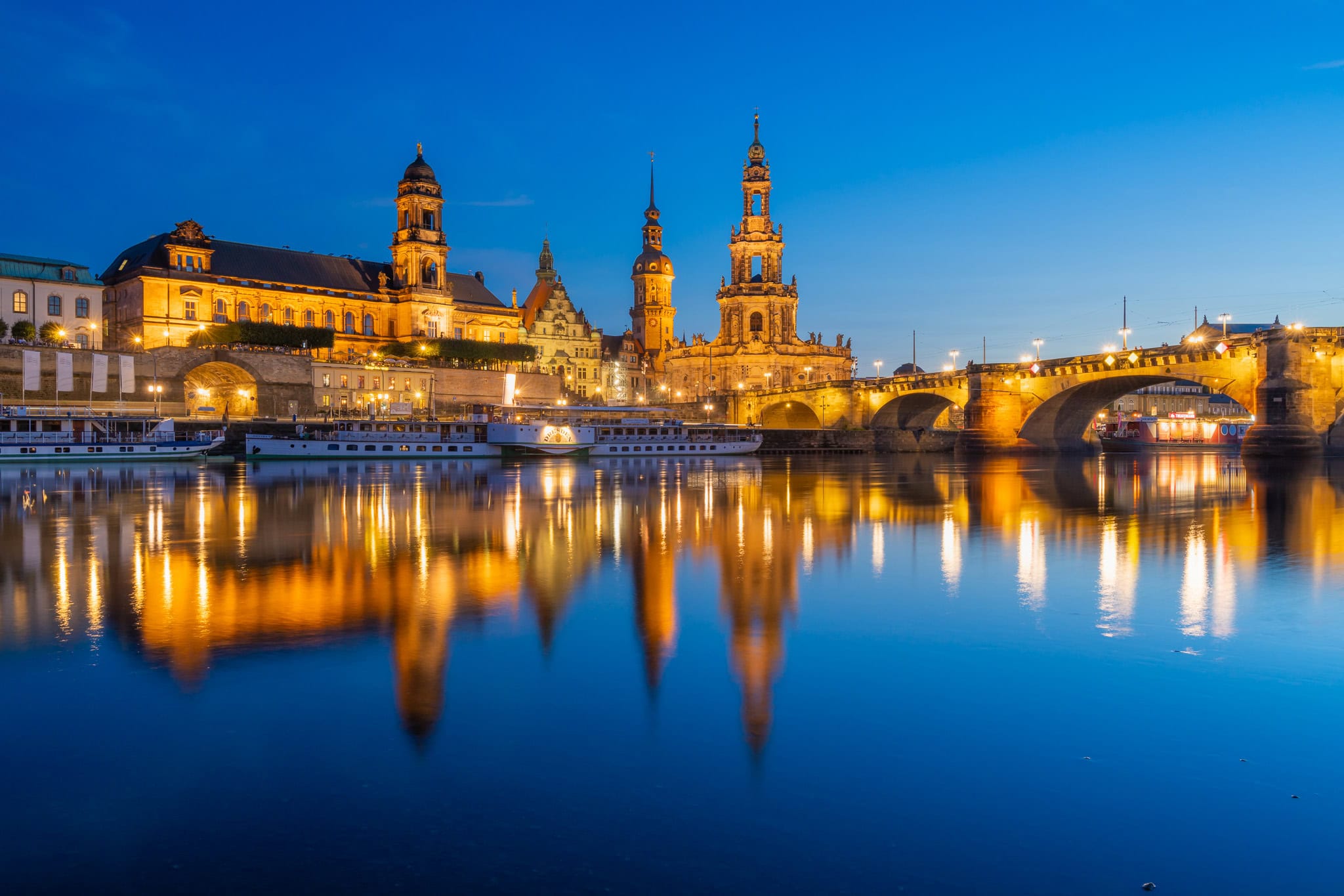 Dresden Castle and Cathedral reflecting in Elbe River at blue hour