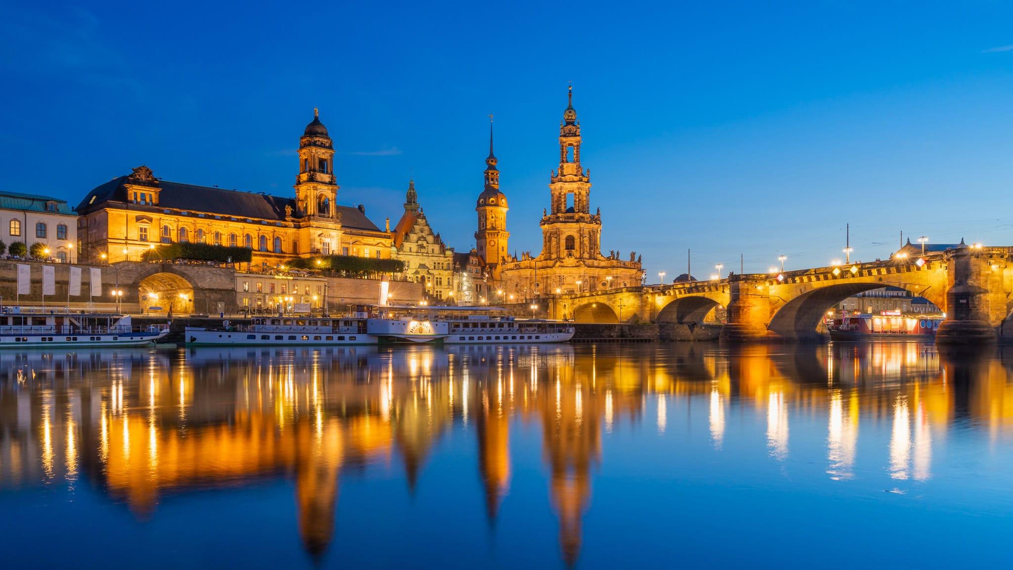 Dresden Castle and Cathedral reflecting in Elbe River at blue hour