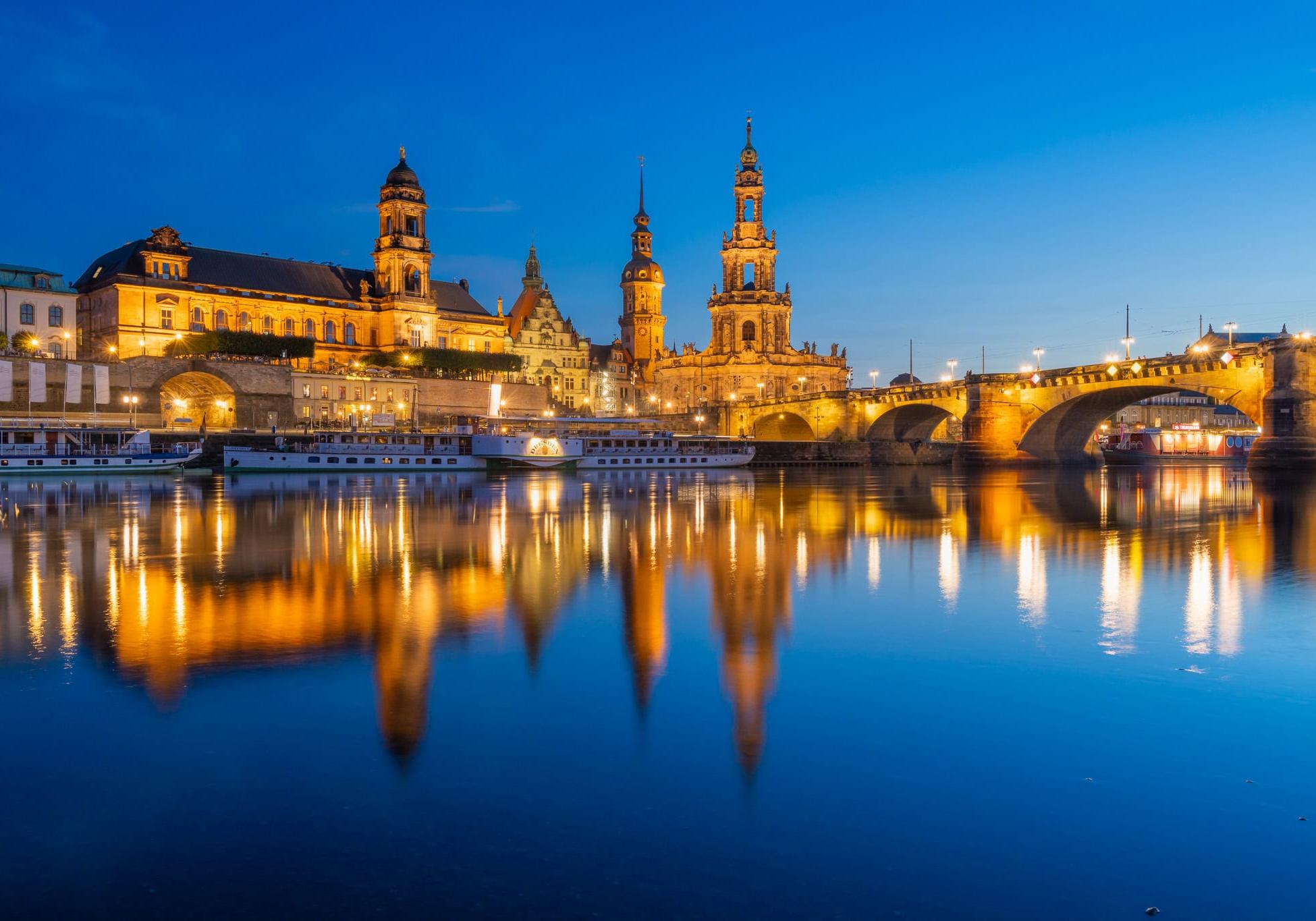 Dresden Castle and Cathedral reflecting in Elbe River at blue hour
