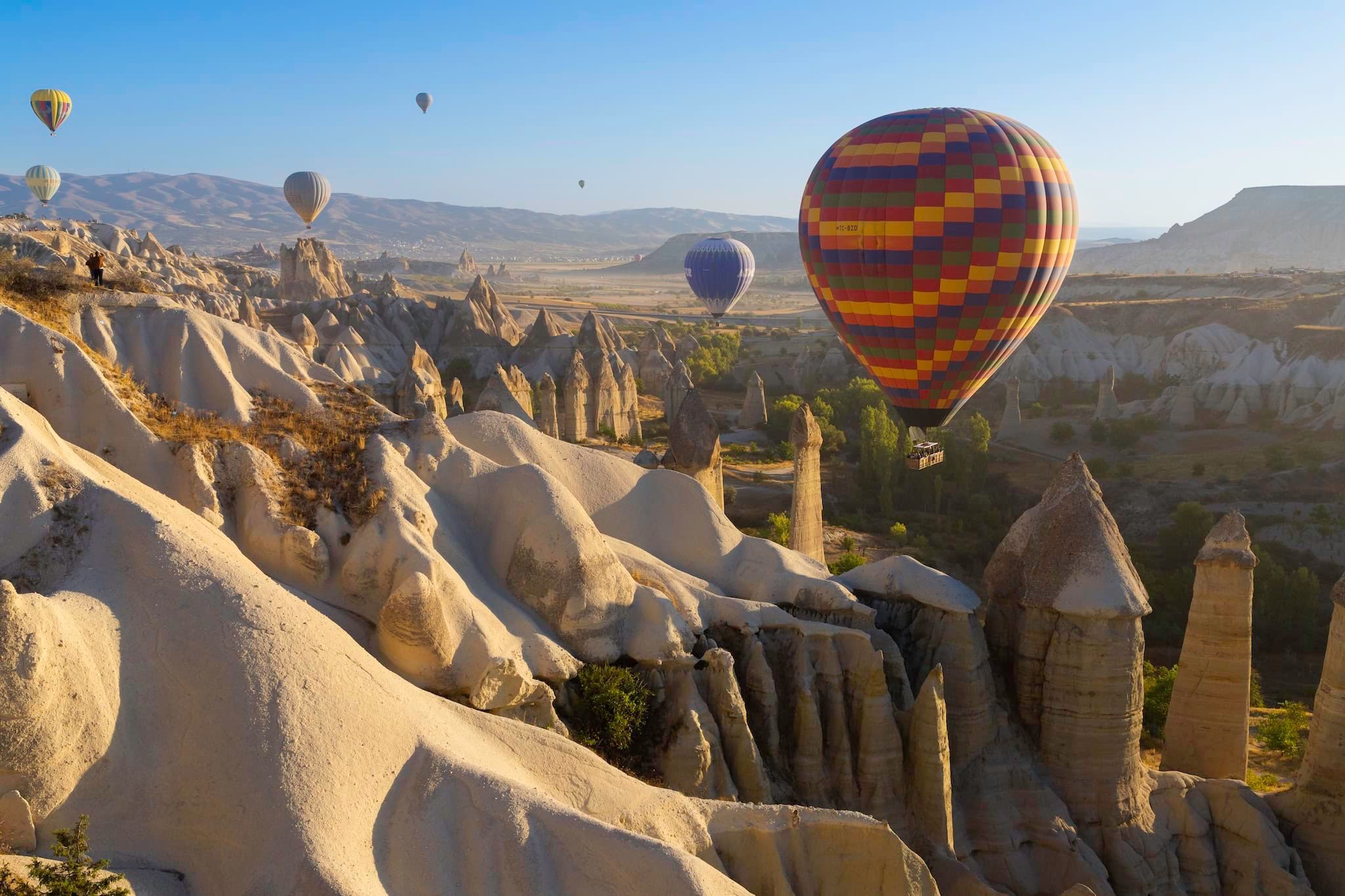 July: Hot-air balloons above the rock formations of Cappadocia, Göreme, Türkiye