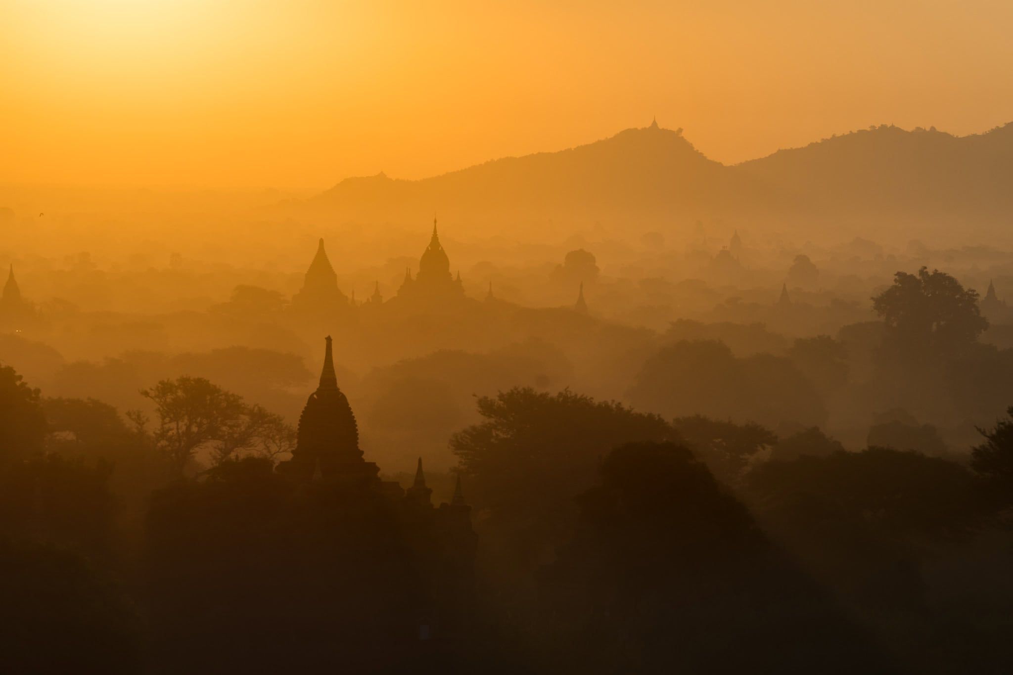 Pagodas and temples silhouetted at sunrise in Bagan, Myanmar