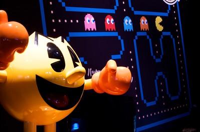 A photo shows a statue of Pac-Man in front of a backdrop showing the game’s maze