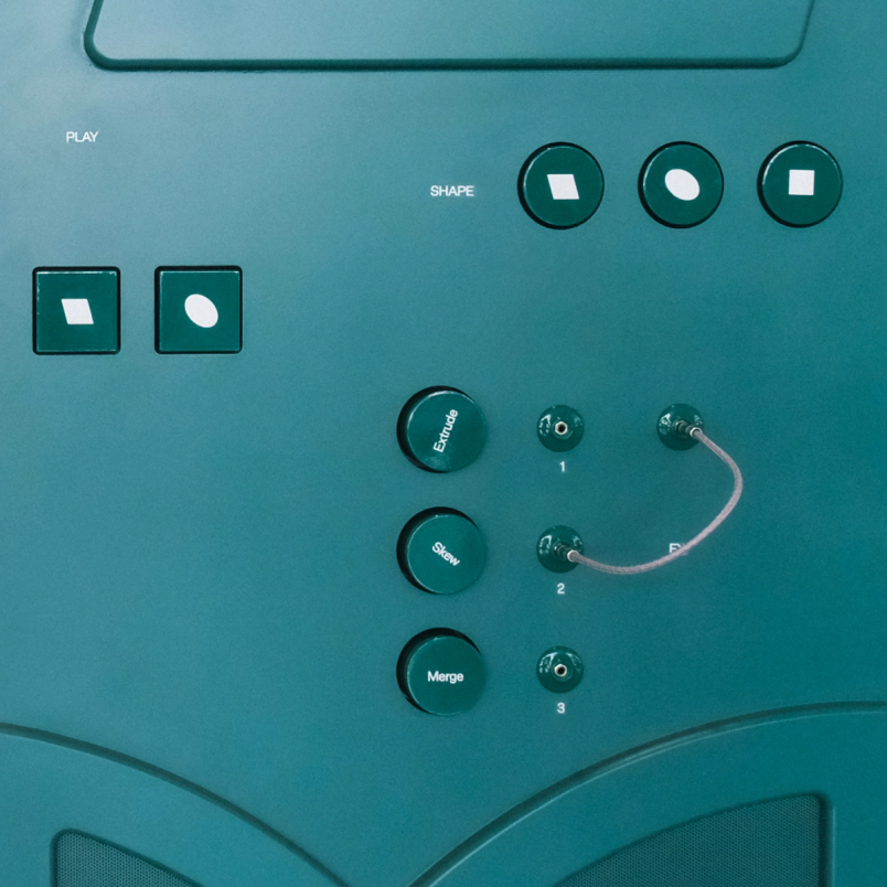Green control panel labeled “Shape” with buttons, knobs, and wires used for design-themed interactivity.