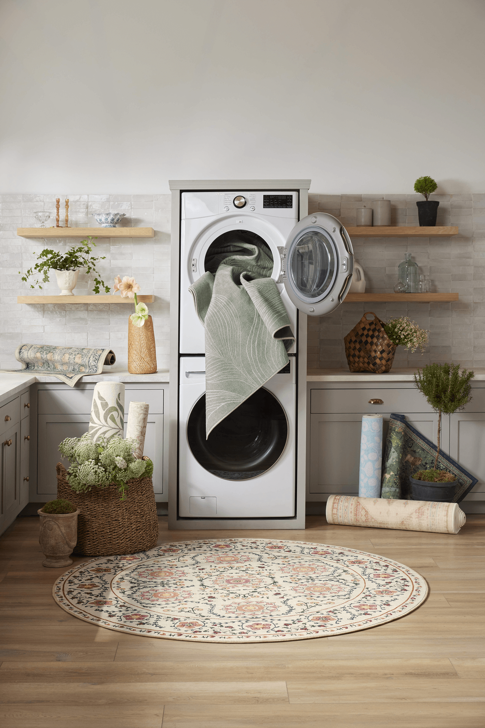 washer and dryer with rug hanging out and rug on the floor in front of it
