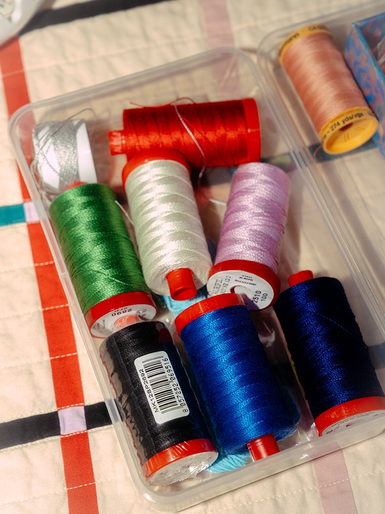 A photograph of a box of colorful threads.