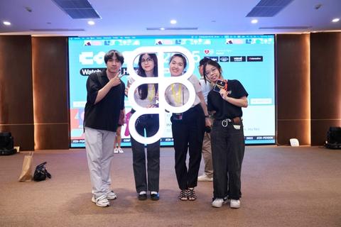 Individuals pose with a bright white, large Figma logo mark
