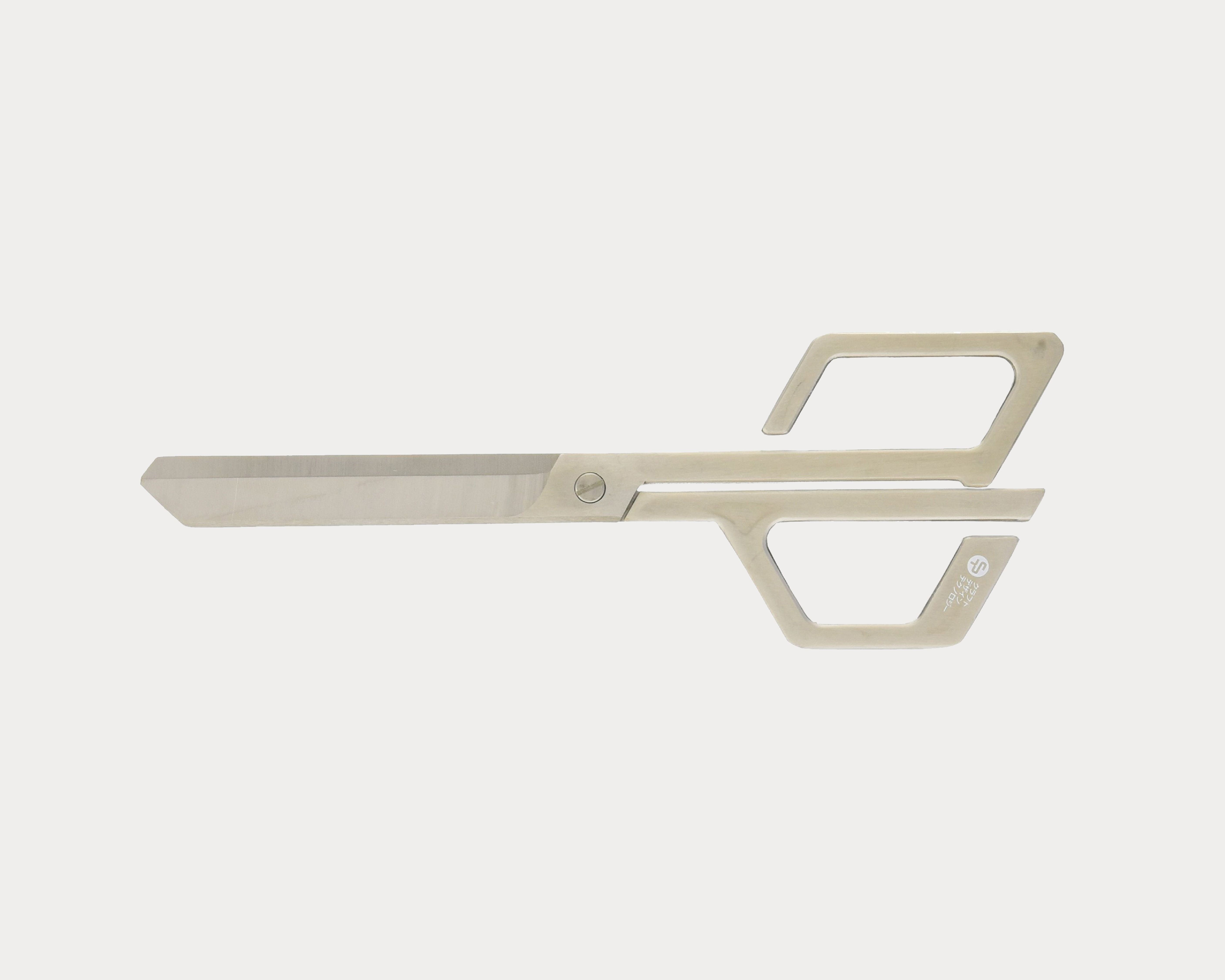 Metallic specialty scissors with angular geometric design, multiple cutouts, and minimalist handle.