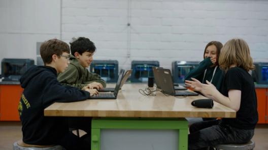 Students sitting around a table with their Chromebooks