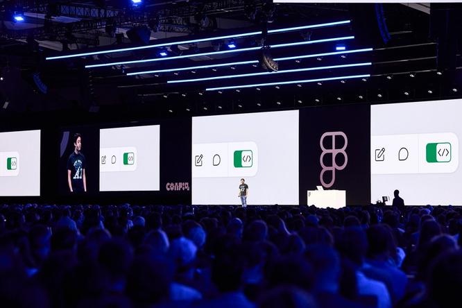 A presenter on stage addresses a large audience. Behind them, multiple large screens display a user interface design, accompanied by the Figma logo and vibrant visuals.