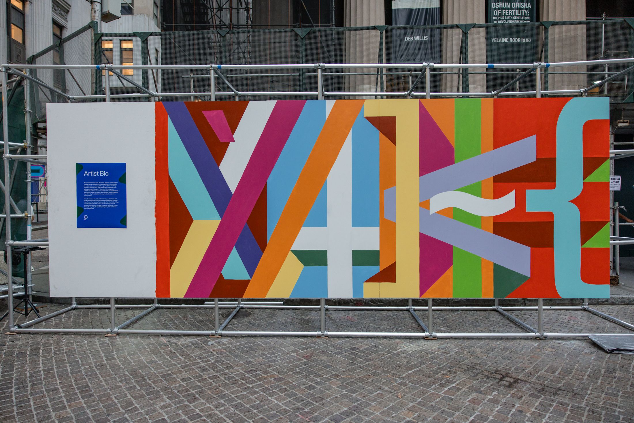 A mural spelling “MAKE” using bold colors and code-inspired shapes.