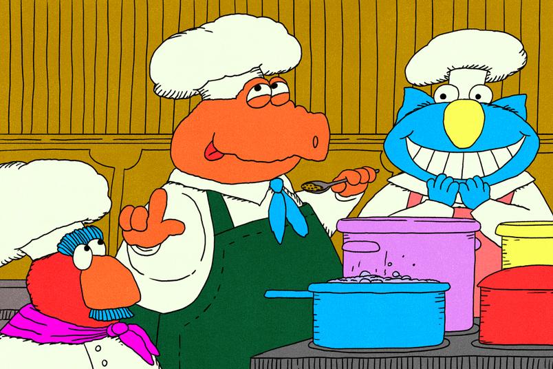 Three cartoon chefs smile and chat while tasting food from colorful pots on a counter.