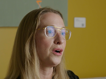 Woman speaking with yellow background