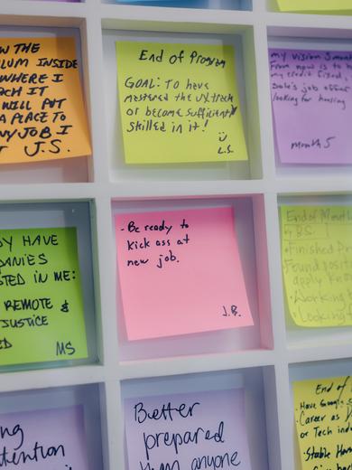 A grid of Post-It notes, one of which says: Be ready to kick ass at new job