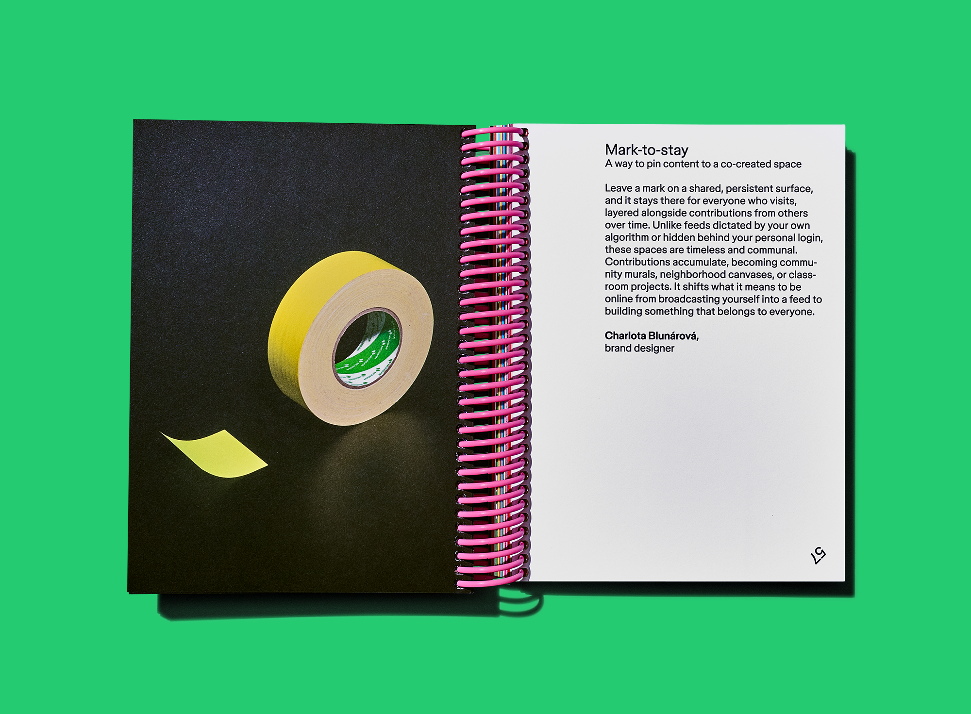 Open notebook showing a roll of yellow masking tape opposite an essay on “Mark-to-stay.”