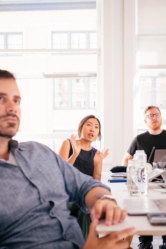 person talking while two others look on
