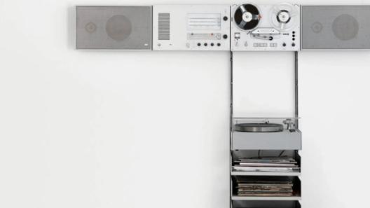 A minimalist Dieter Rams audio system with speakers, reel-to-reel, radio controls, and a turntable neatly integrated into a wall unit.