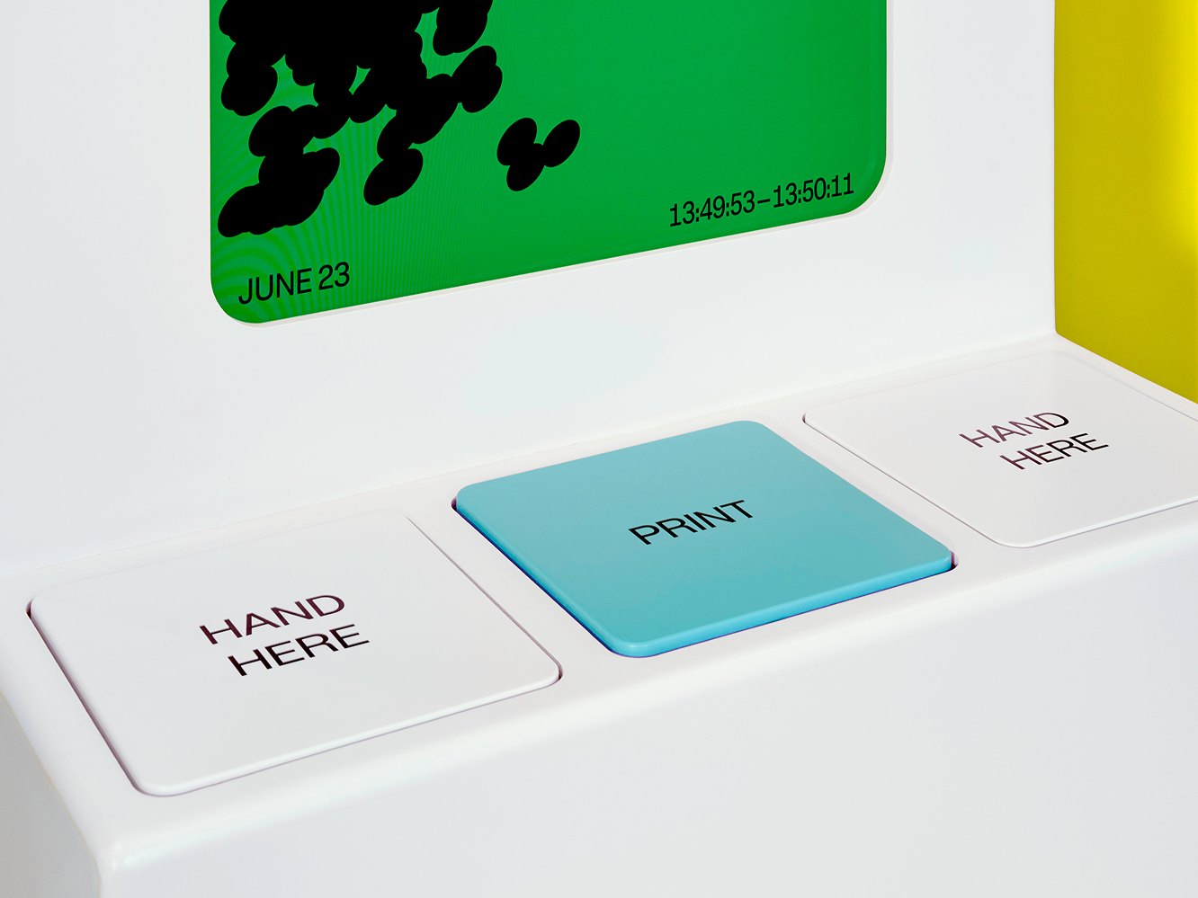 Three large buttons on a kiosk tell them where to place their hands and how to print