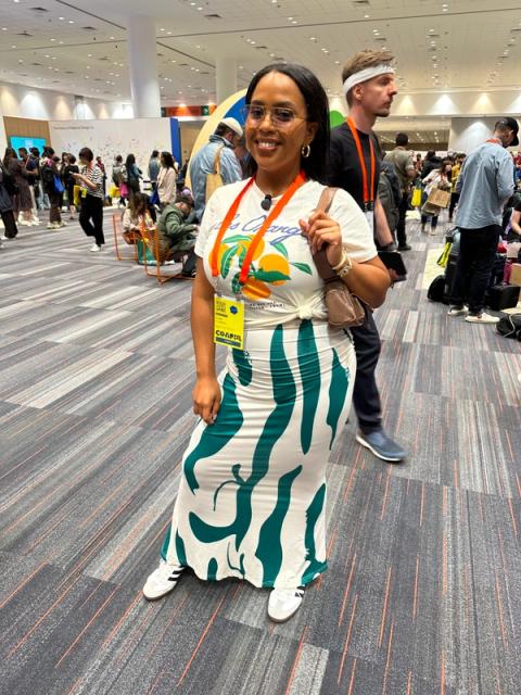 A woman wears a tight graphic maxi skirt and a graphic tee