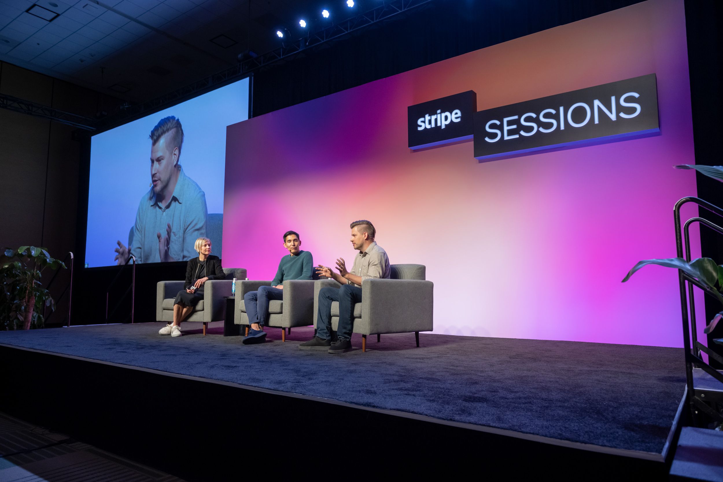 A photograph of Katie Dill, Yuhki Yamashita, and Karri Saarinen sitting onstage at Stripe Sessions.