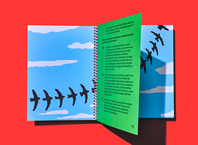 Spiral-bound book opens to illustrated birds in flight with interview page layered over the spread.