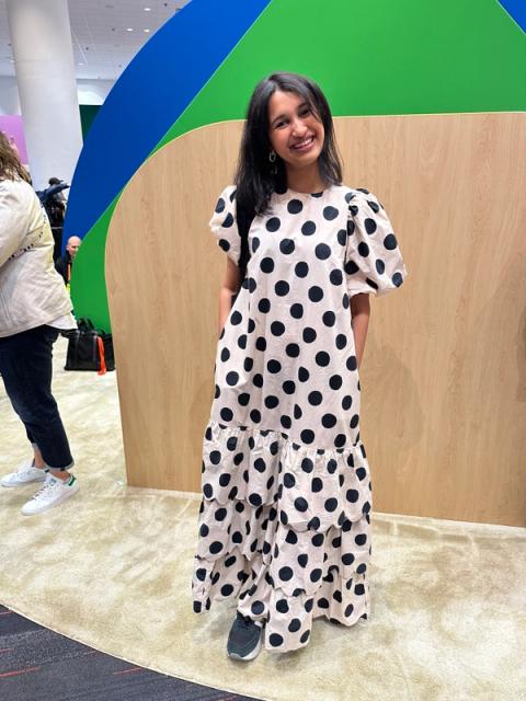 A woman wears a tiered polka dot maxi dress