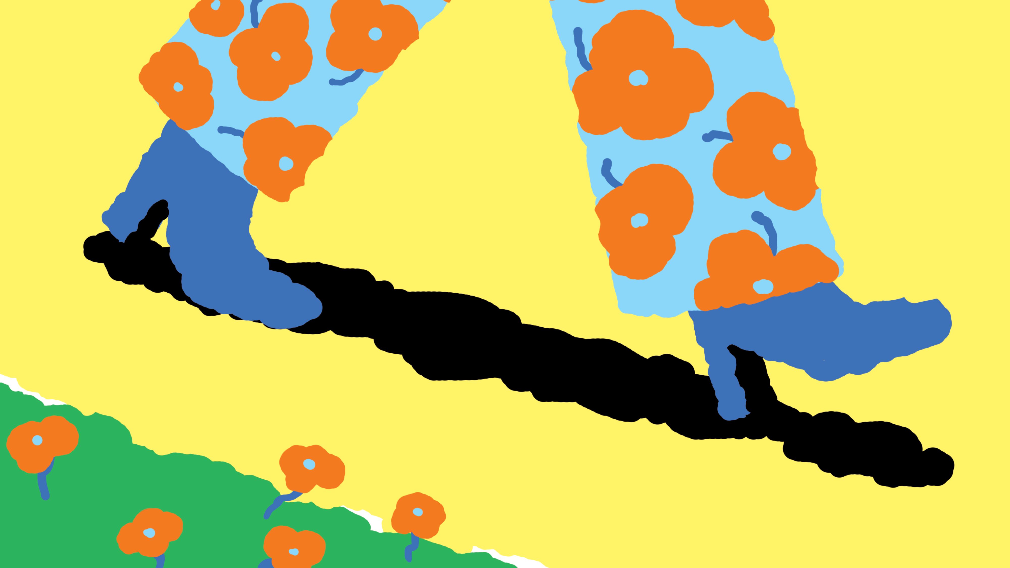 Person standing on a black path wearing blue shoes and light blue floral pants, with orange flowers blooming in green grass nearby.