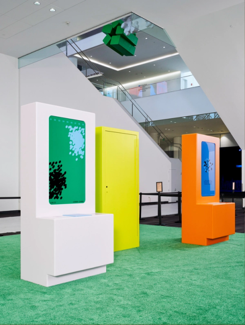 White, yellow, and orange kiosks with screens