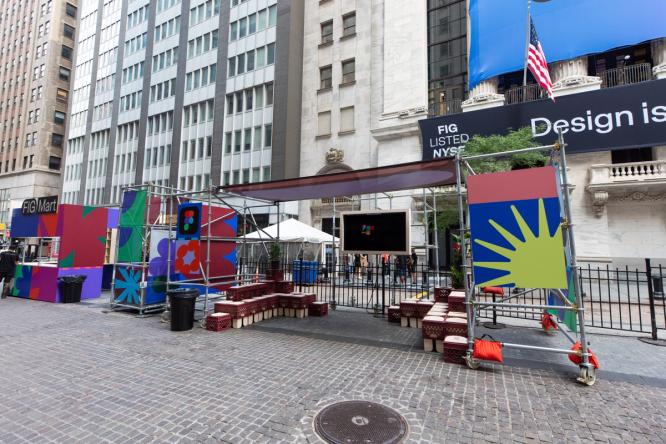 Outdoor installation titled “Figma Commons” in front of the NYSE, with seating, signage, and graphic panels arranged along the street.